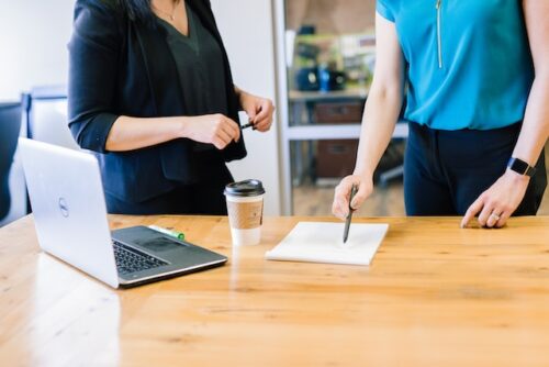 two women looking at documents