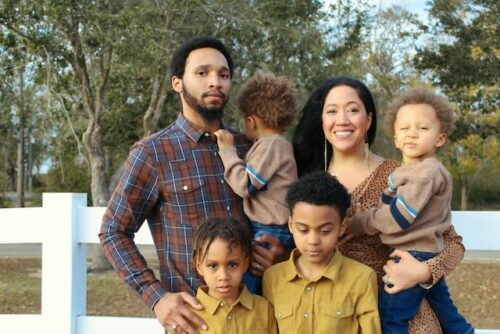 portrait of man and woman holding children