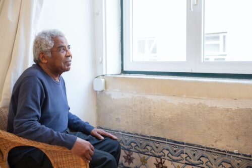 old man looking out window