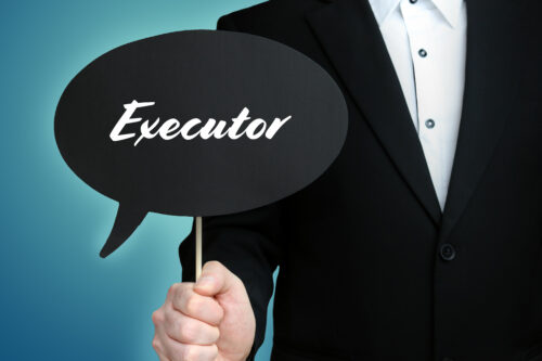 A person in a black suit and white shirt holds a black speech bubble sign with the word "Executor" written on it, against a blue background.